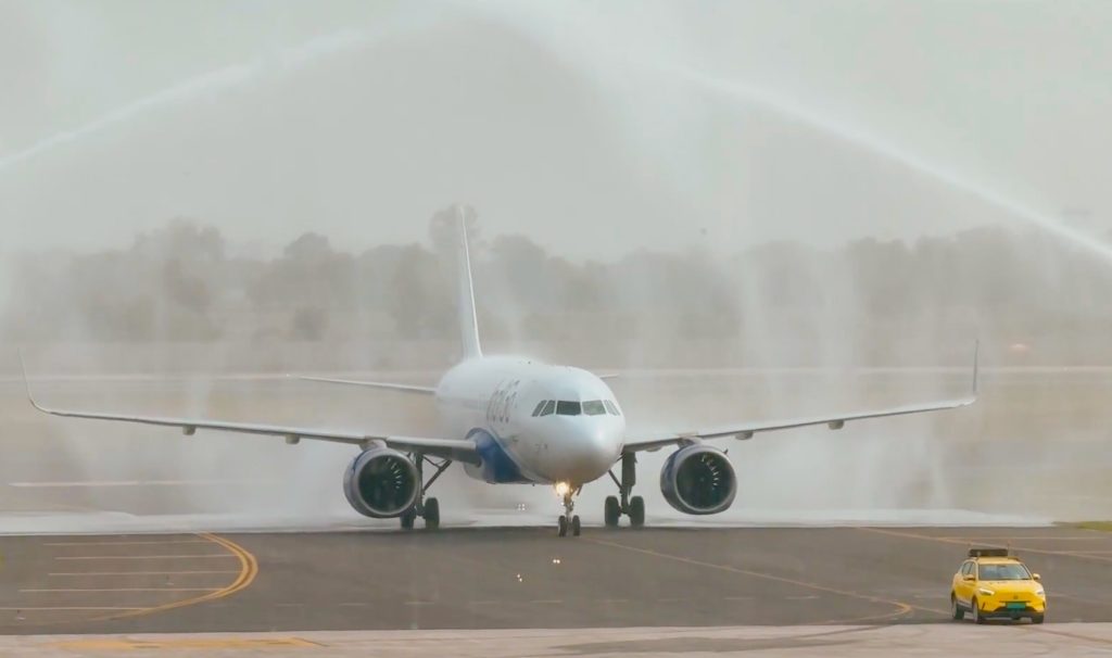 IndiGo Airbus A320neo (VT-IOM) receives a traditional water cannon salute as it becomes the first commercial flight to land at Noida International Airport (Jewar) on June 15, 2026.