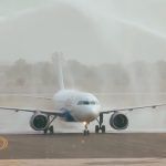 IndiGo Airbus A320neo (VT-IOM) receives a traditional water cannon salute as it becomes the first commercial flight to land at Noida International Airport (Jewar) on June 15, 2026.